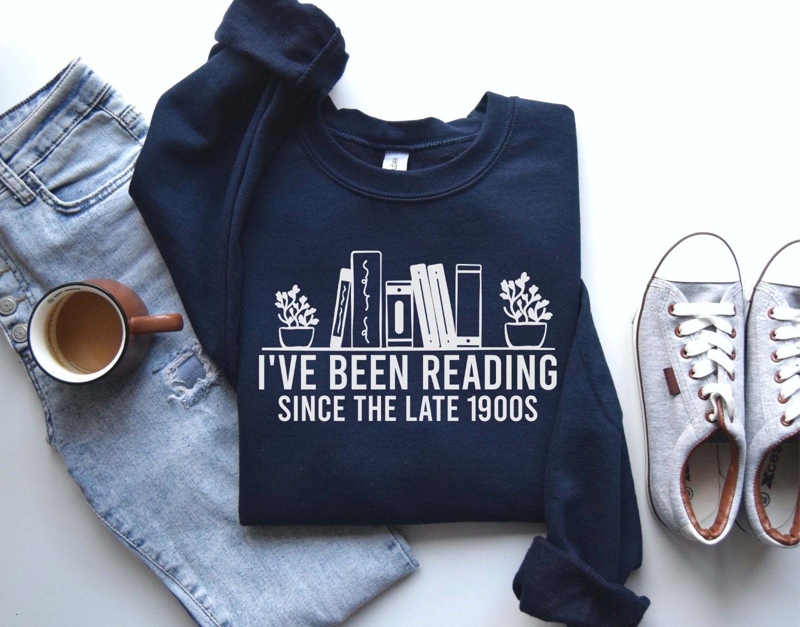 A Gildan 18000 sweatshirt with the saying "I've been reading since the late 1900s"