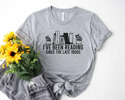 A bella canvas 3001 shirt with the saying "i've been reading since the late 1900s"