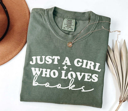 A comfort colors shirt with the saying "Just a girl who loves books"