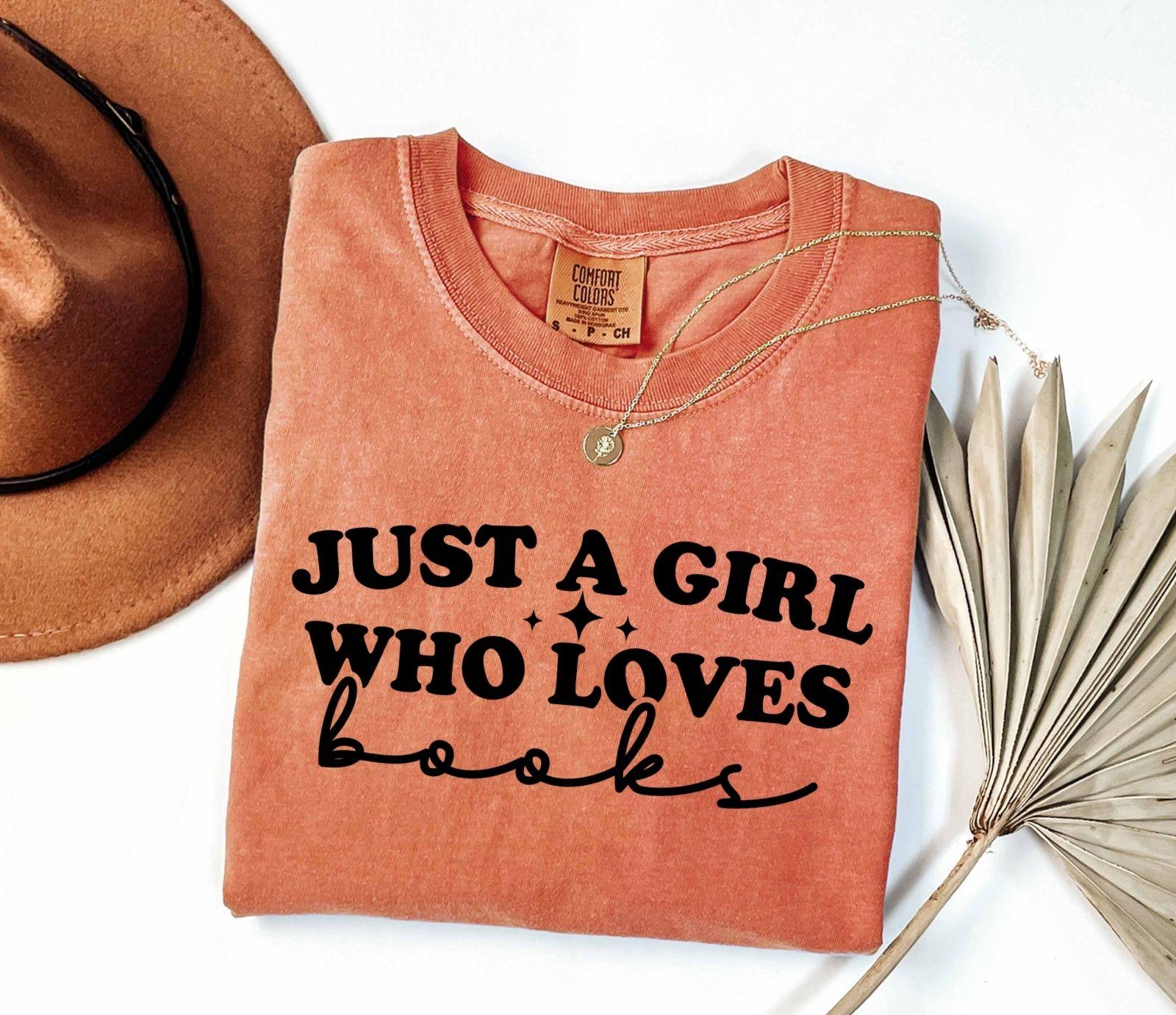 A comfort colors shirt with the saying "Just a girl who loves books"