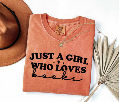 A comfort colors shirt with the saying "Just a girl who loves books"