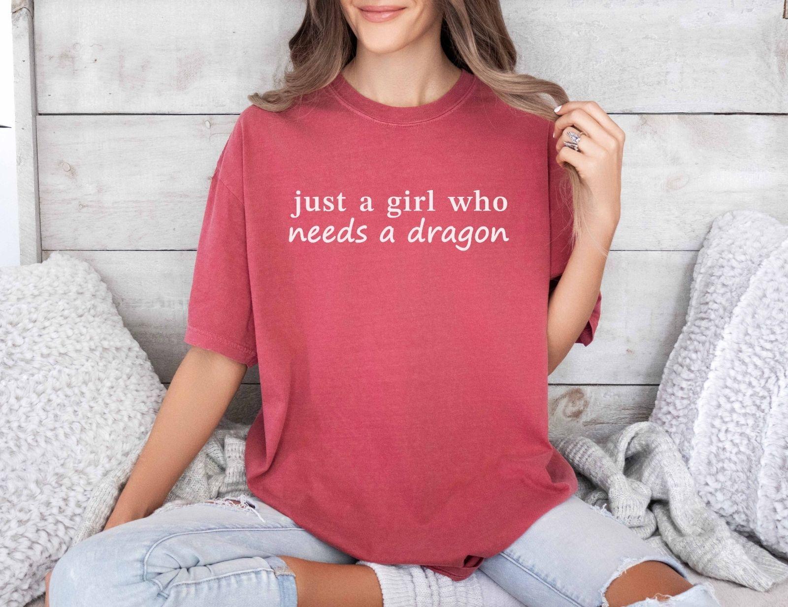 A comfort colors® shirt with the saying "just a girl who needs a dragon"