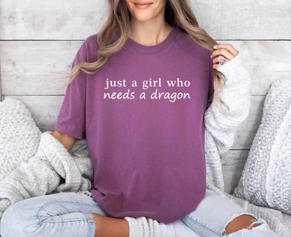 A comfort colors® shirt with the saying "just a girl who needs a dragon"