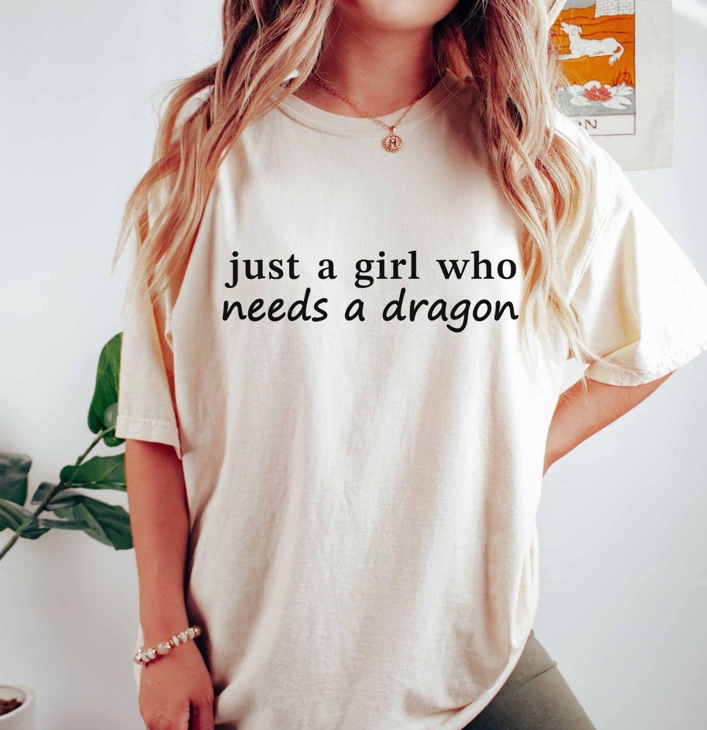 A comfort colors® shirt with the saying "just a girl who needs a dragon"