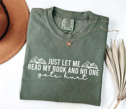 A comfort colors shirt with the saying "just let me read my book and no one gets hurt"