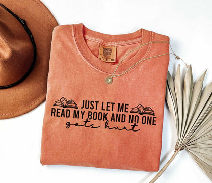 A comfort colors shirt with the saying "just let me read my book and no one gets hurt"