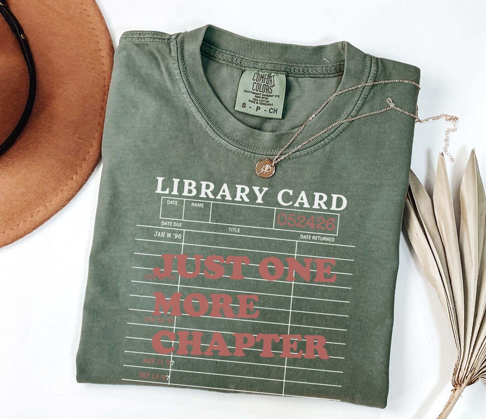 A comfort colors® shirt with the saying "just one more chapter"