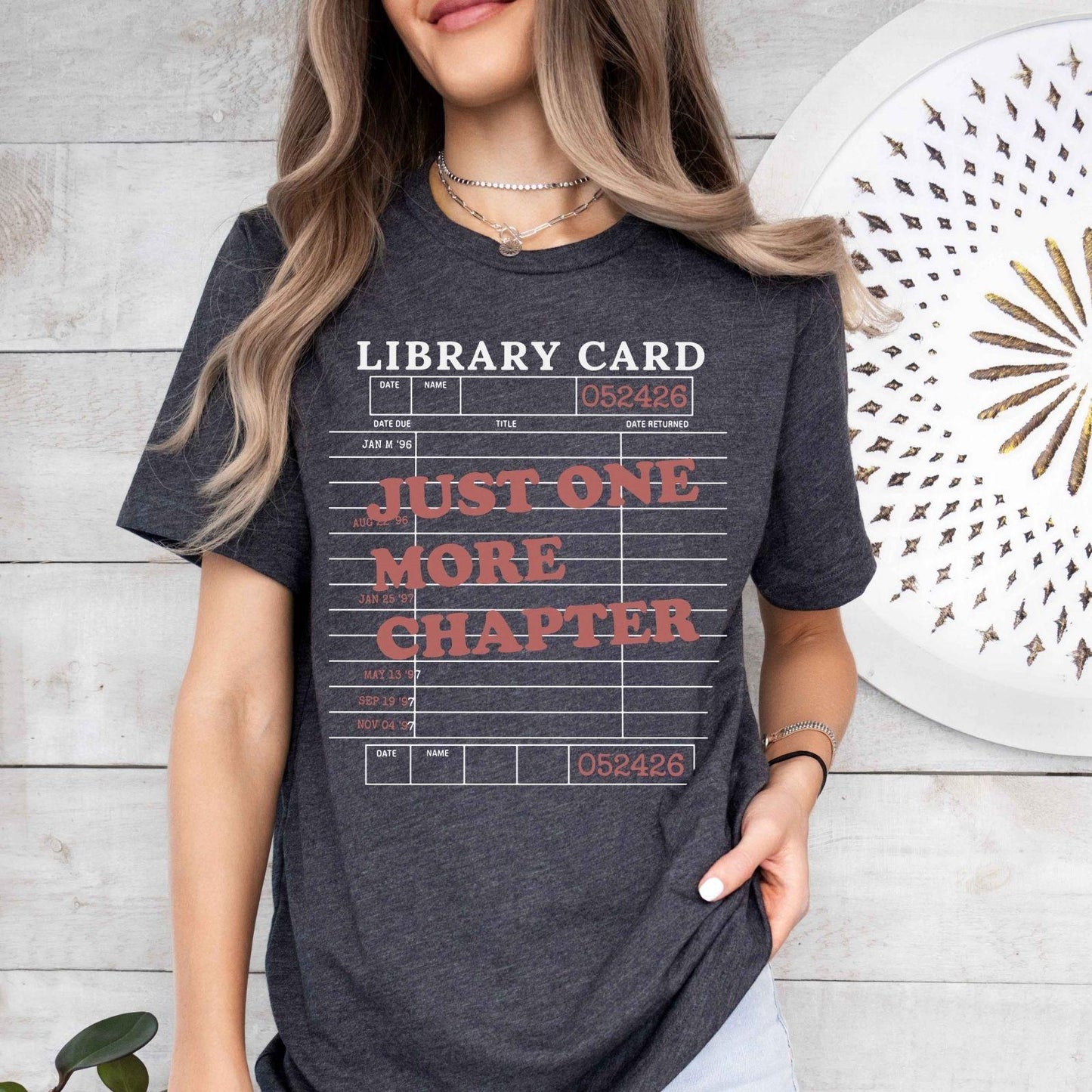 A bella canvas 3001 shirt with the saying "Just one more chapter"