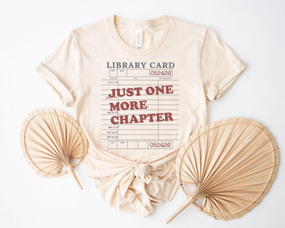 A bella canvas 3001 shirt with the saying "Just one more chapter"