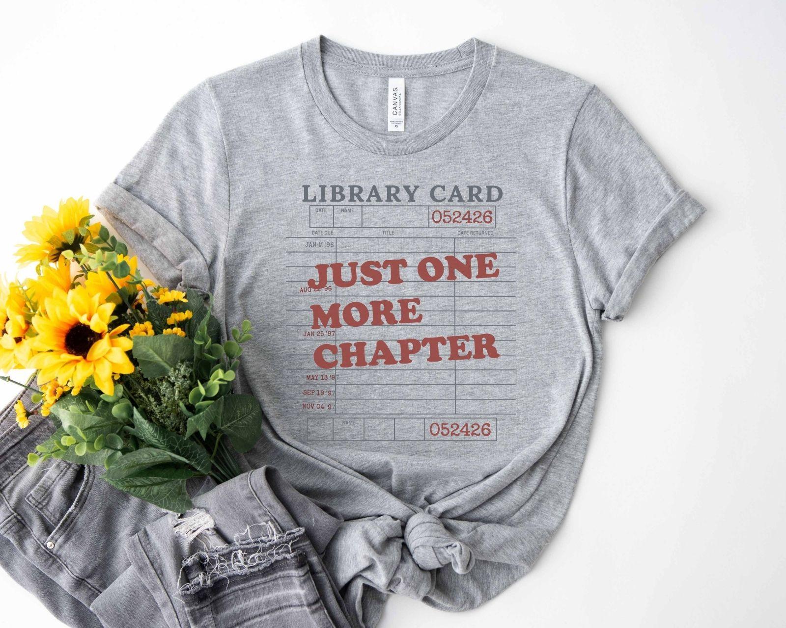 A bella canvas 3001 shirt with the saying "Just one more chapter"