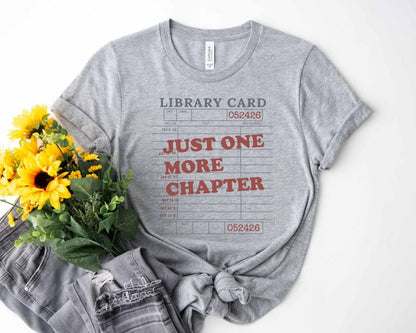 A bella canvas 3001 shirt with the saying "Just one more chapter"
