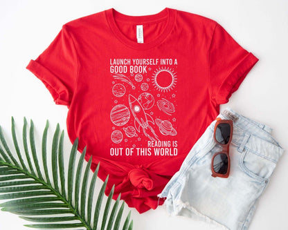 A bella canvas 3001 shirt with the saying "launch yourself into a good book reading is out of this world"