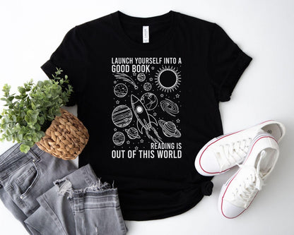 A bella canvas 3001 shirt with the saying "launch yourself into a good book reading is out of this world"