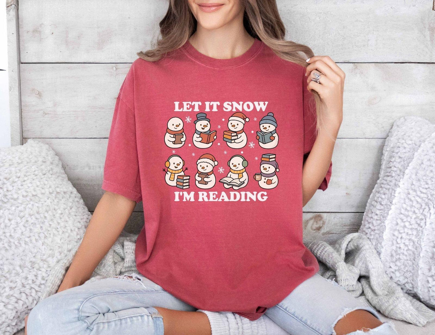 A comfort colors shirt with the saying "Let it snow I'm reading"