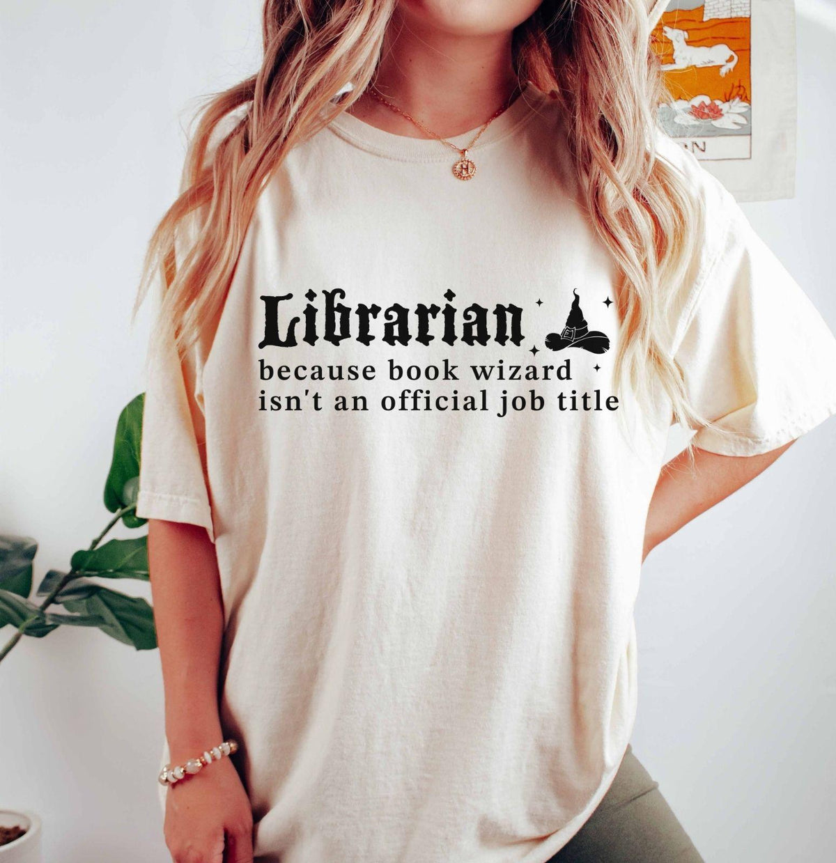 A comfort colors® shirt with the saying "librarian because book wizard isn't an official job title"