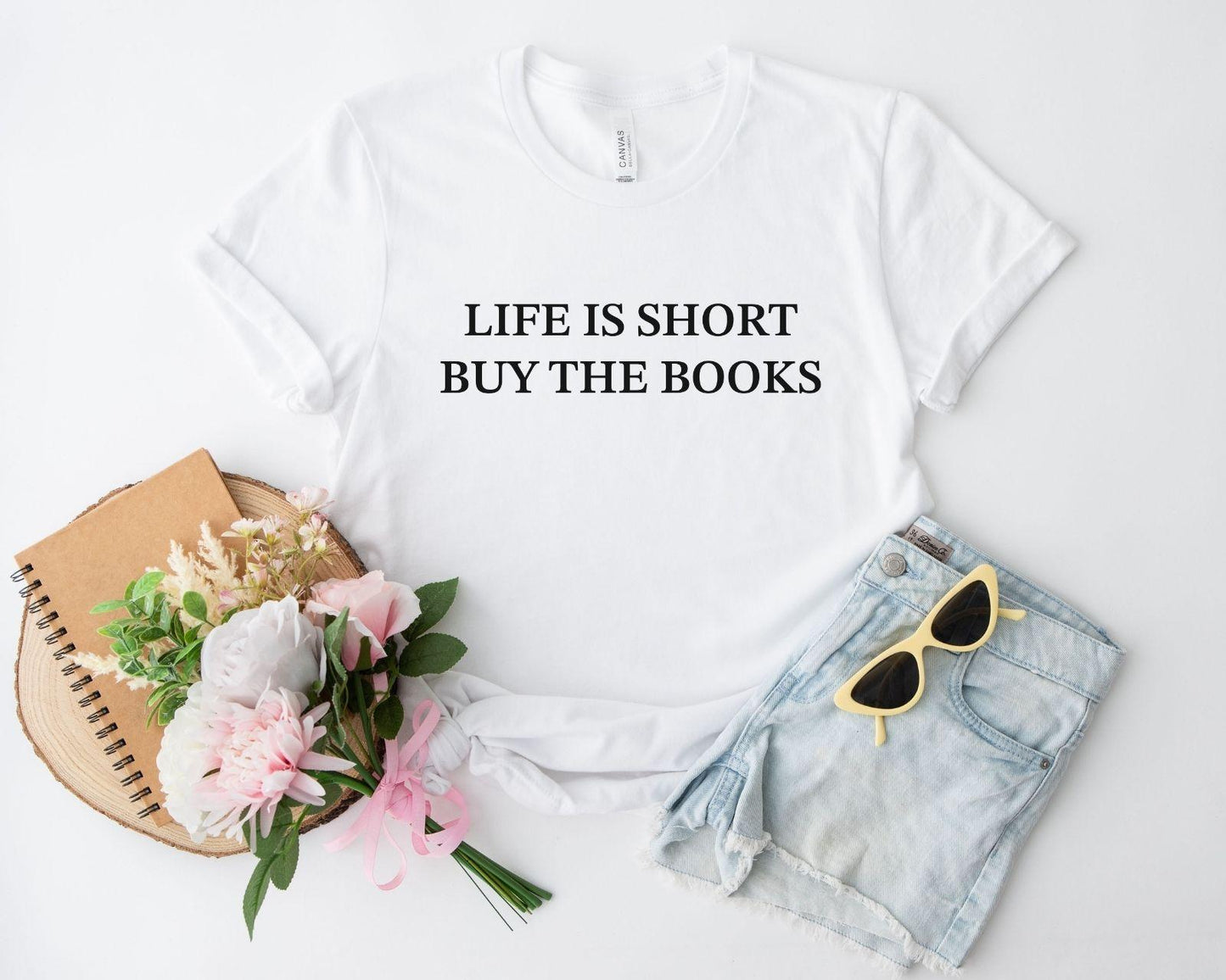 A comfort colors® shirt with the saying "life is short buy the books"
