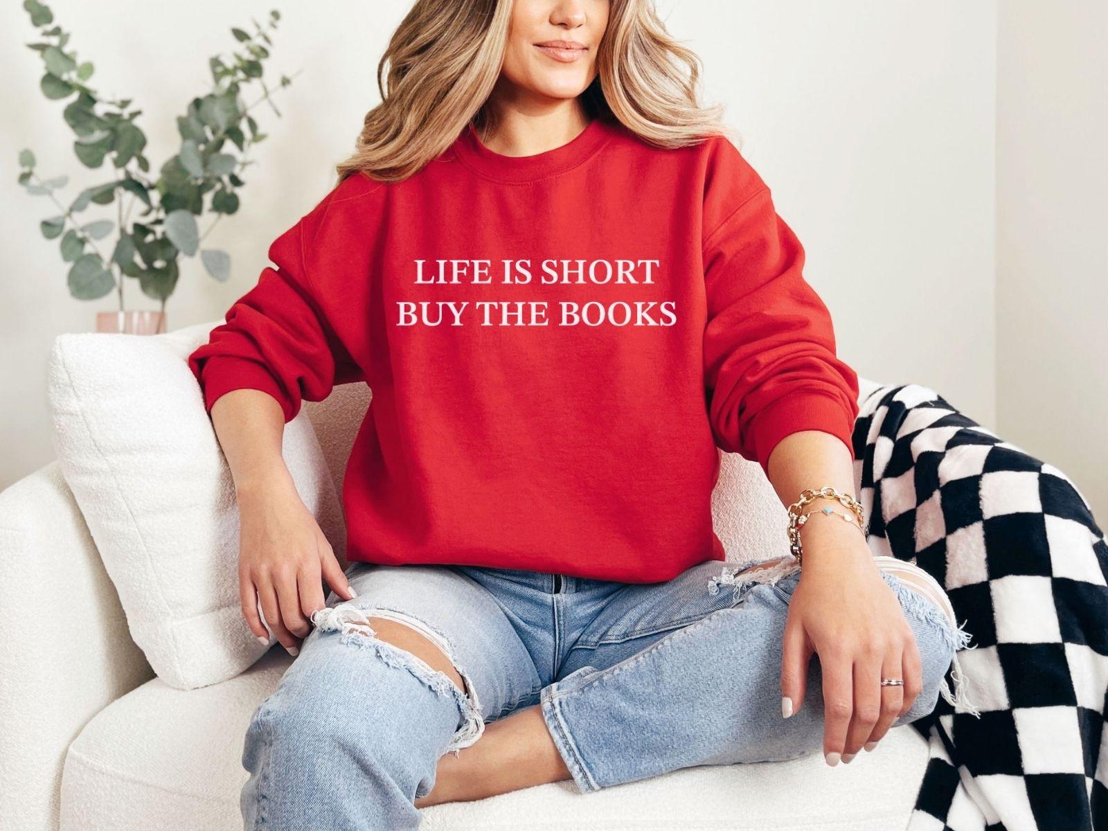 A Gildan 18000 sweatshirt with the saying "life is short buy the books"