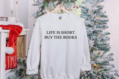 A Gildan 18000 sweatshirt with the saying "life is short buy the books"