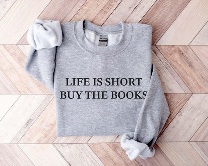 A Gildan 18000 sweatshirt with the saying "life is short buy the books"