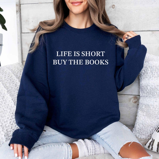 A Gildan 18000 sweatshirt with the saying "life is short buy the books"