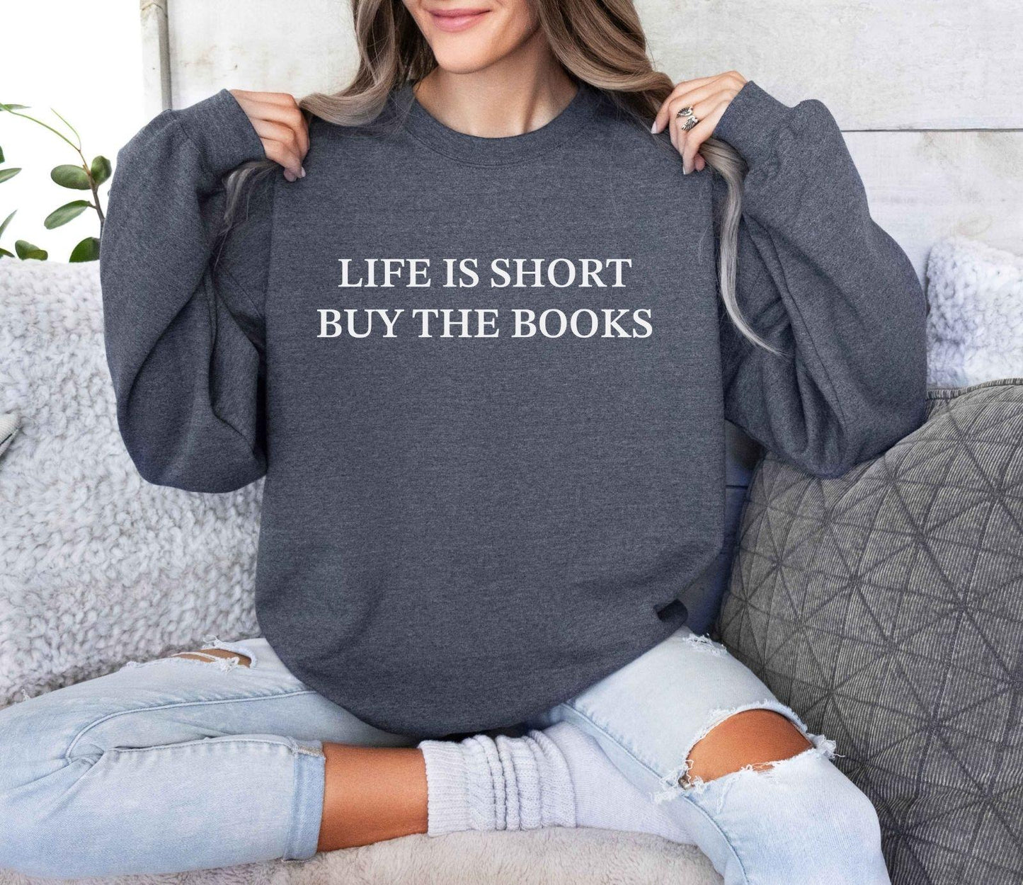 A Gildan 18000 sweatshirt with the saying "life is short buy the books"