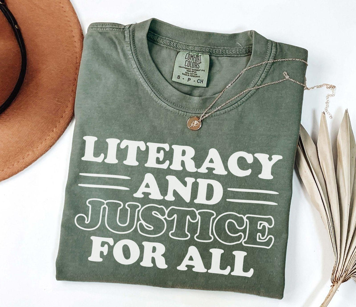 A comfort colors® shirt with the saying "Literacy and justice for all"