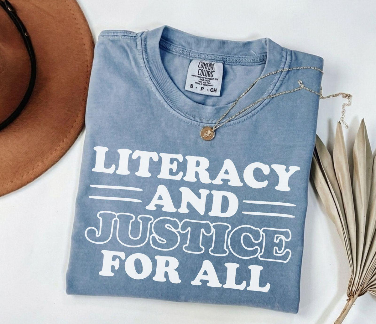 A comfort colors® shirt with the saying "Literacy and justice for all"