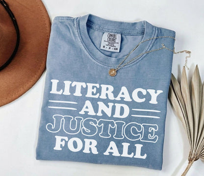 A comfort colors® shirt with the saying "Literacy and justice for all"