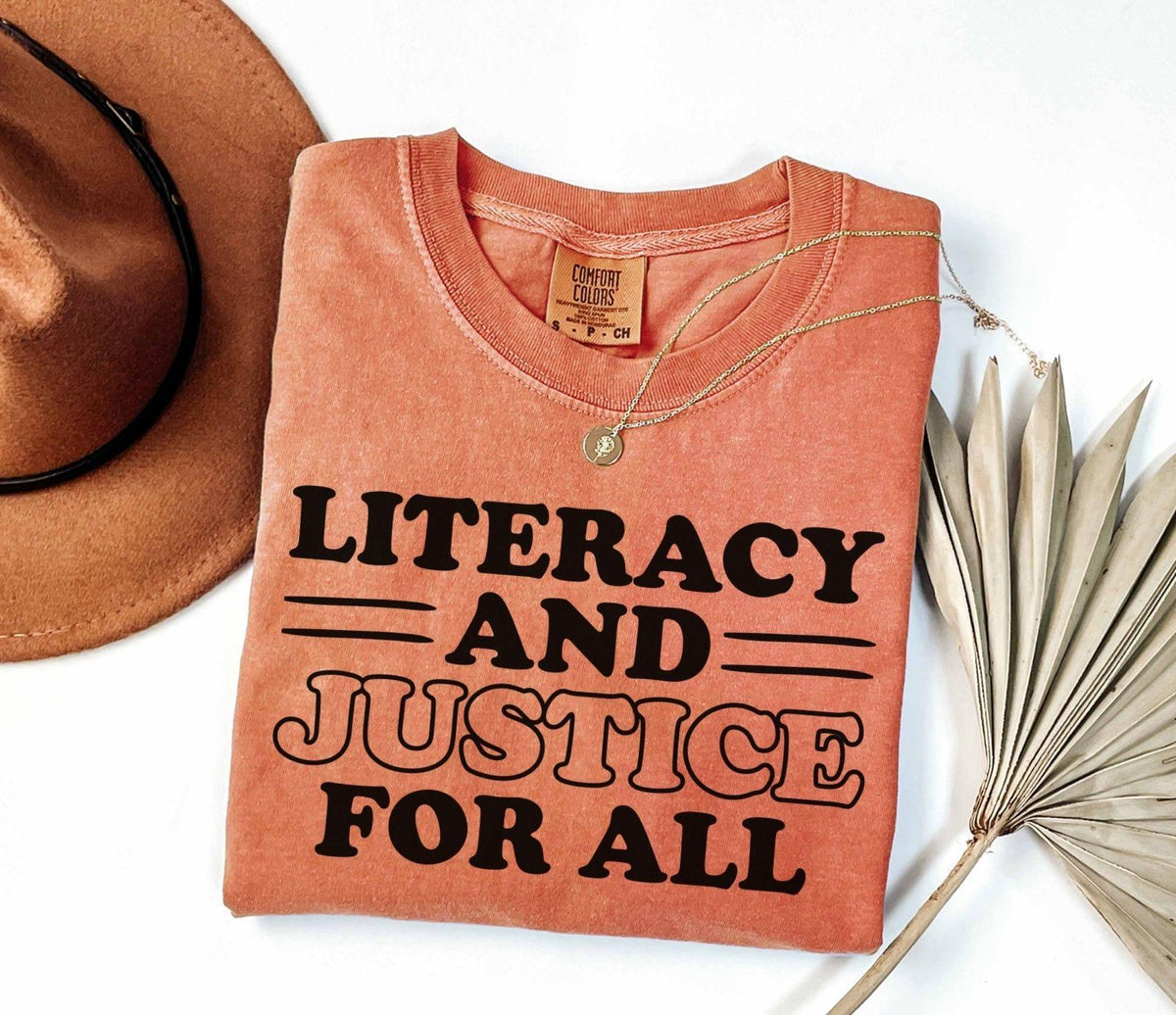 A comfort colors® shirt with the saying "Literacy and justice for all"