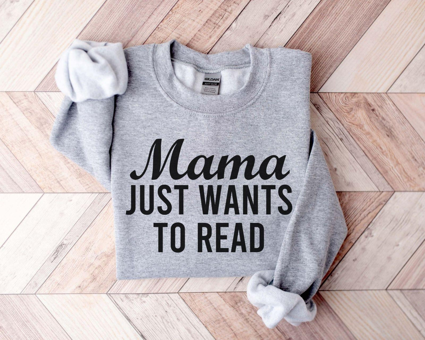 A Gildan 18000 sweatshirt with the saying "mama just wants to read"