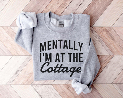 A Gildan 18000 sweatshirt with the saying "Mentally I'm at the cottage"