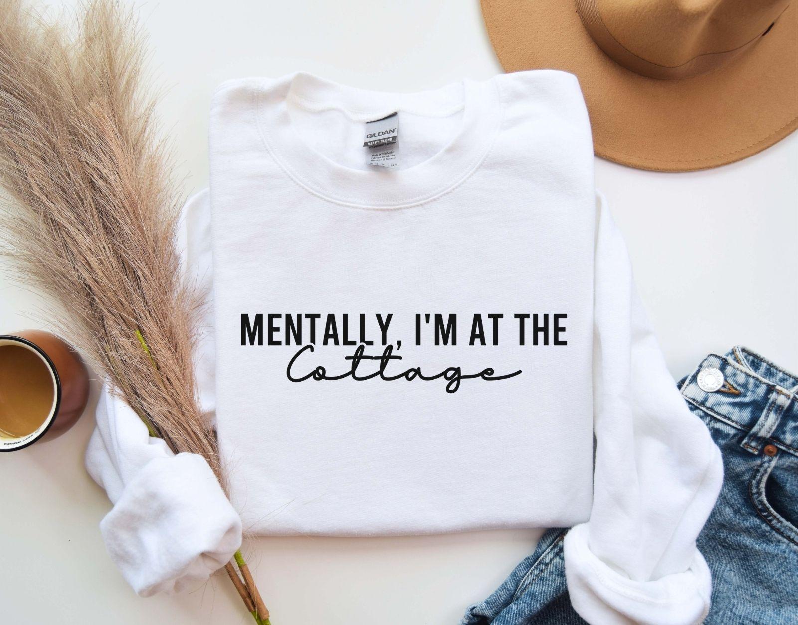 A Gildan 18000 sweatshirt with the saying "Mentally im at the cottage"