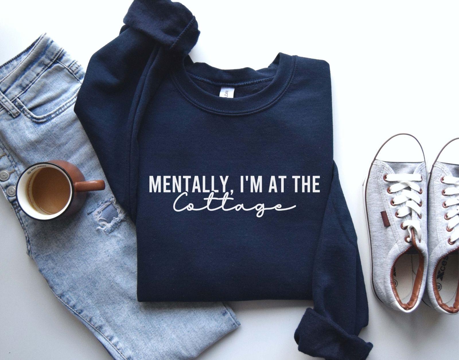A Gildan 18000 sweatshirt with the saying "Mentally im at the cottage"