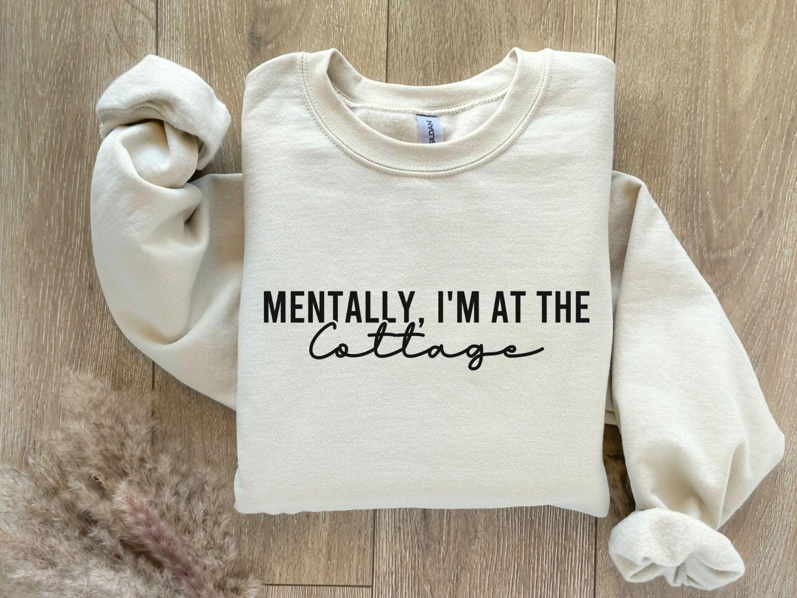 A Gildan 18000 sweatshirt with the saying "Mentally im at the cottage"