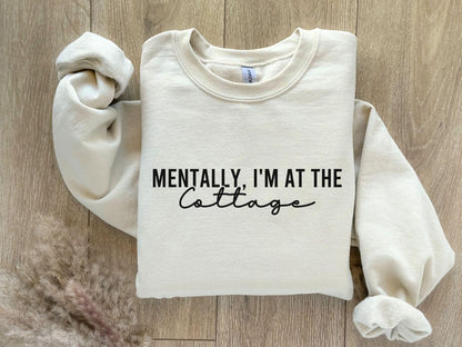 A Gildan 18000 sweatshirt with the saying "Mentally im at the cottage"