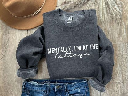 A Gildan 18000 sweatshirt with the saying "Mentally im at the cottage"