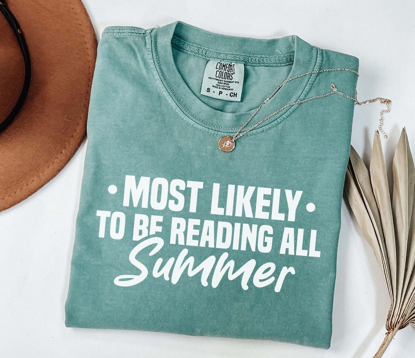 A comfort colors shirt with the saying "Most likely to be reading all summer"