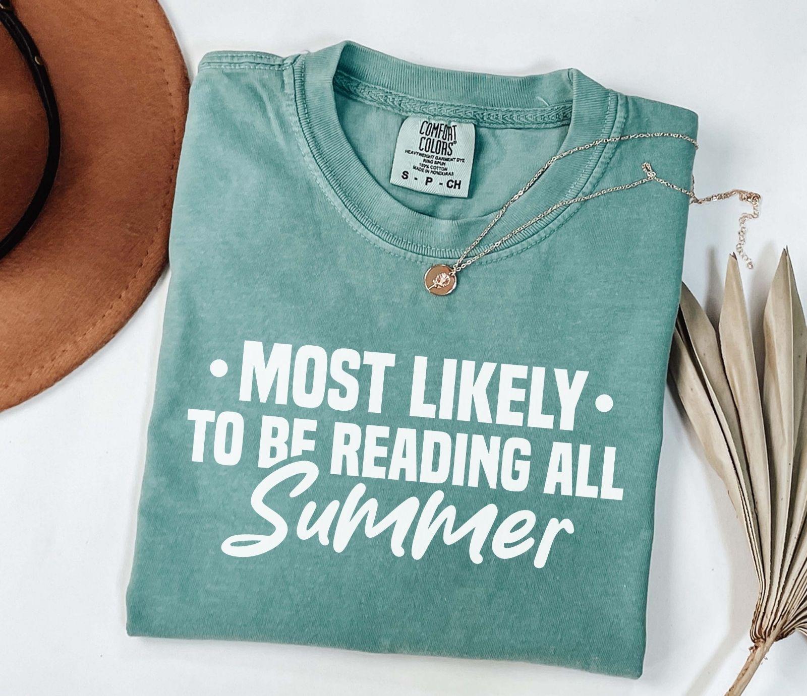 A comfort colors shirt with the saying "Most likely to be reading all summer"