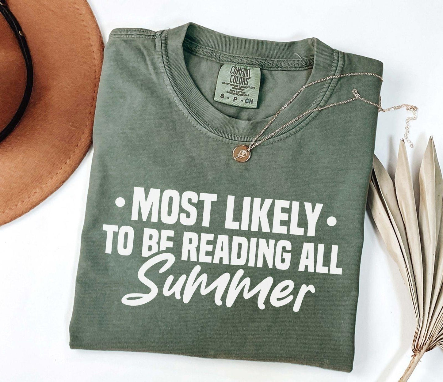 A comfort colors shirt with the saying "Most likely to be reading all summer"