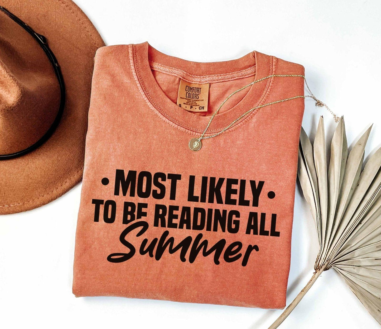 A comfort colors shirt with the saying "Most likely to be reading all summer"