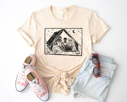 A bella canvas 3001 shirt with the saying "mothman, bigfoot and horned reading books"