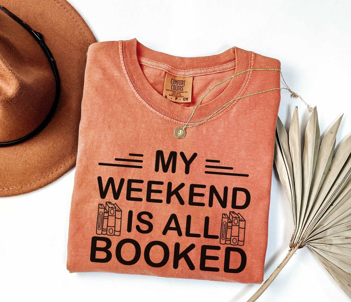 A comfort colors® shirt with the saying "My weekend is all booked"