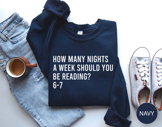 Navy sweatshirt with text, jeans, mug, and shoes on a white background