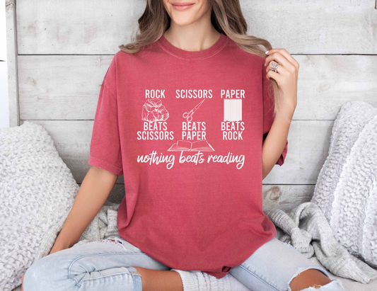 A comfort colors shirt with the saying "nothing beats reading"