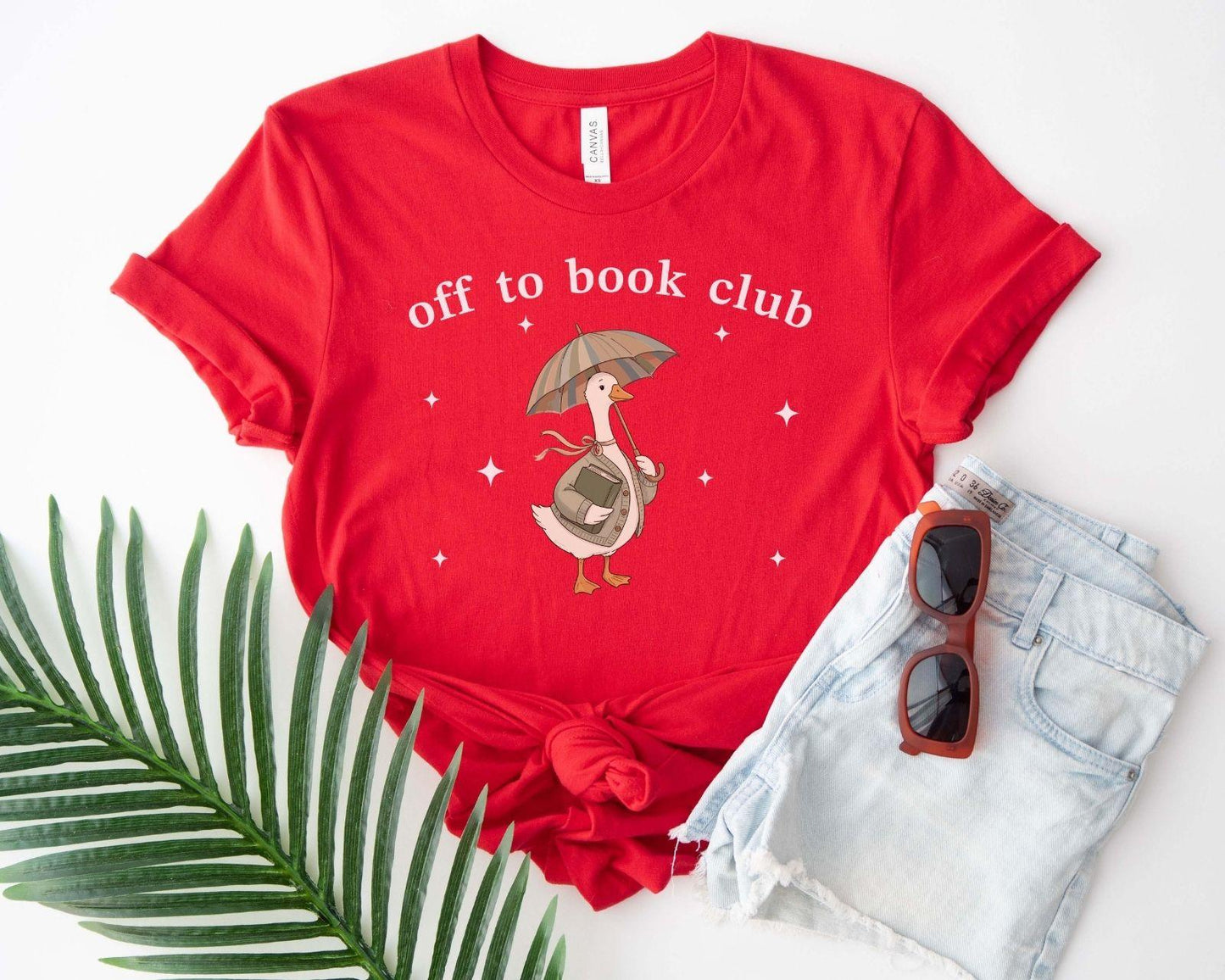 A bella canvas 3001 shirt with the saying "off to book club"