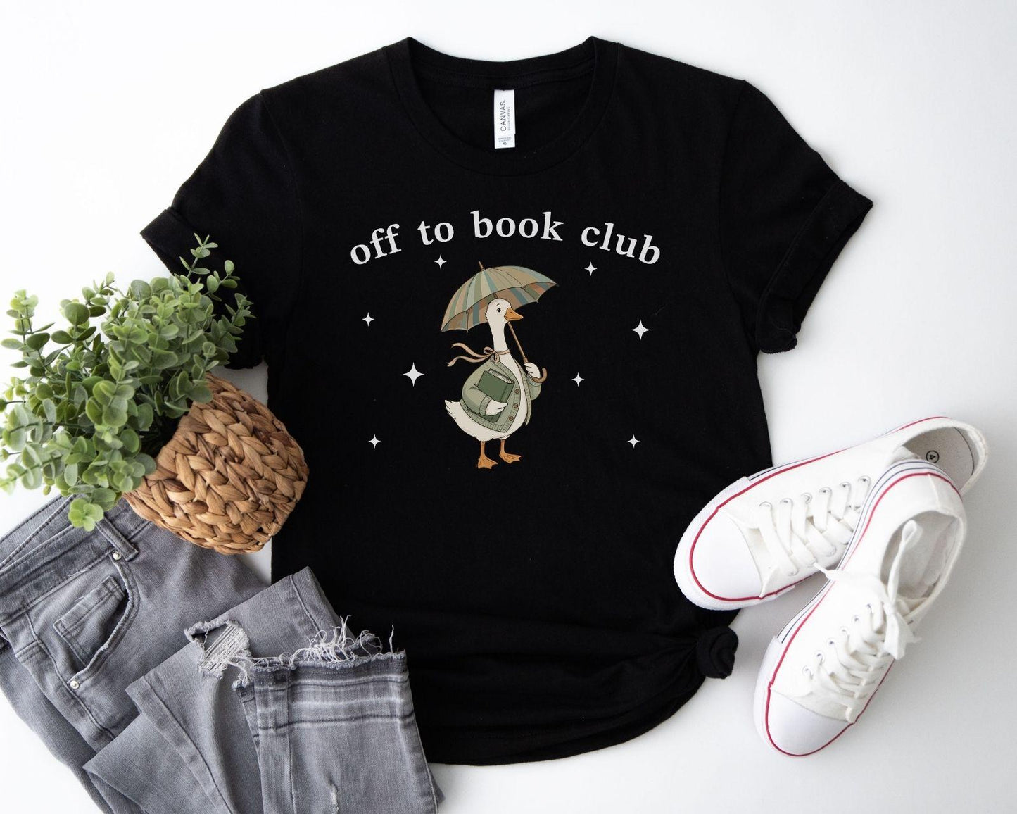 A bella canvas 3001 shirt with the saying "off to book club"