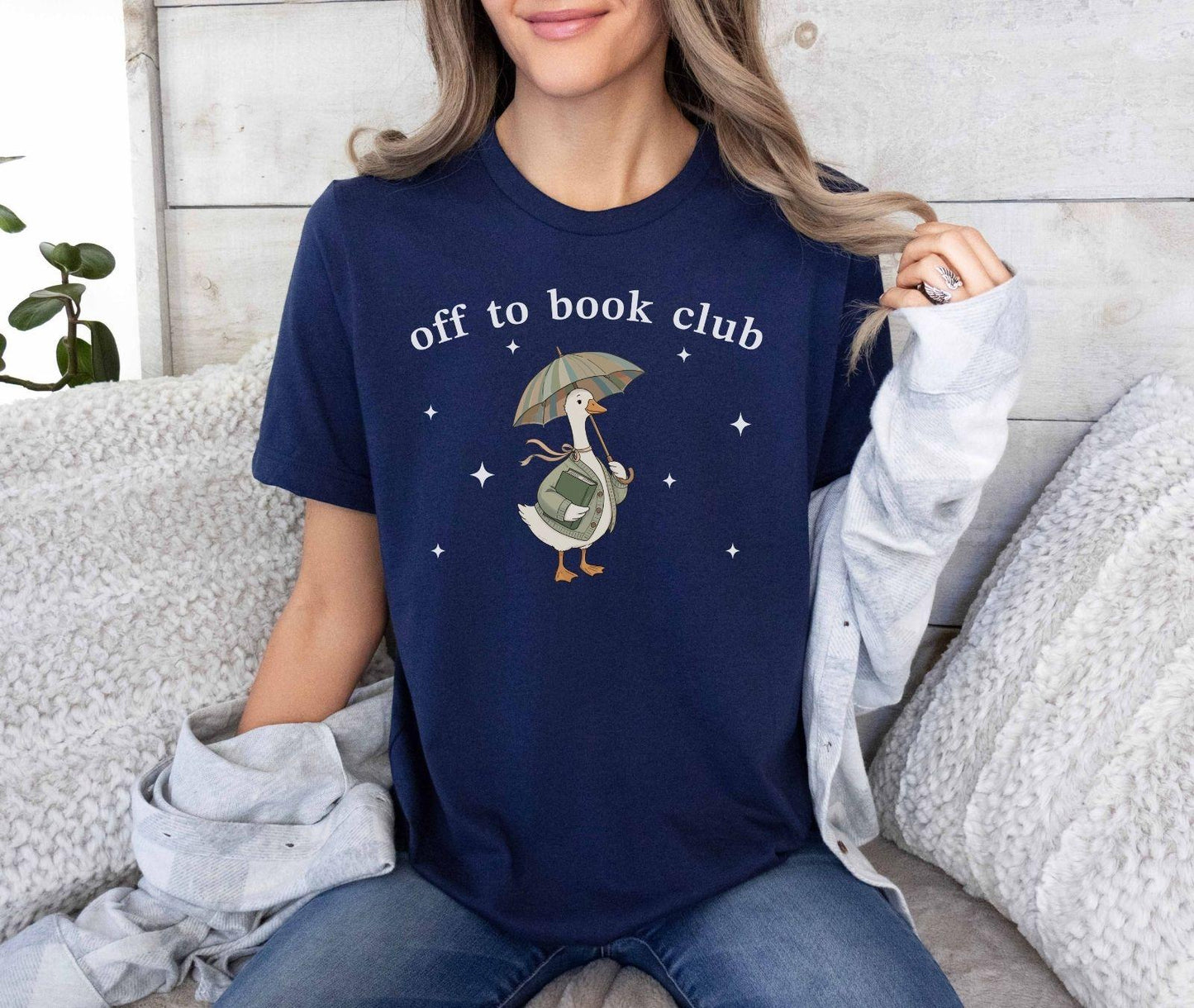 A bella canvas 3001 shirt with the saying "off to book club"