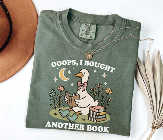 A comfort colors® shirt with the saying "ooops i bought another book"
