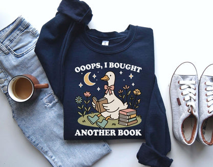 A Gildan 18000 sweatshirt with the saying "oops i bought another book"