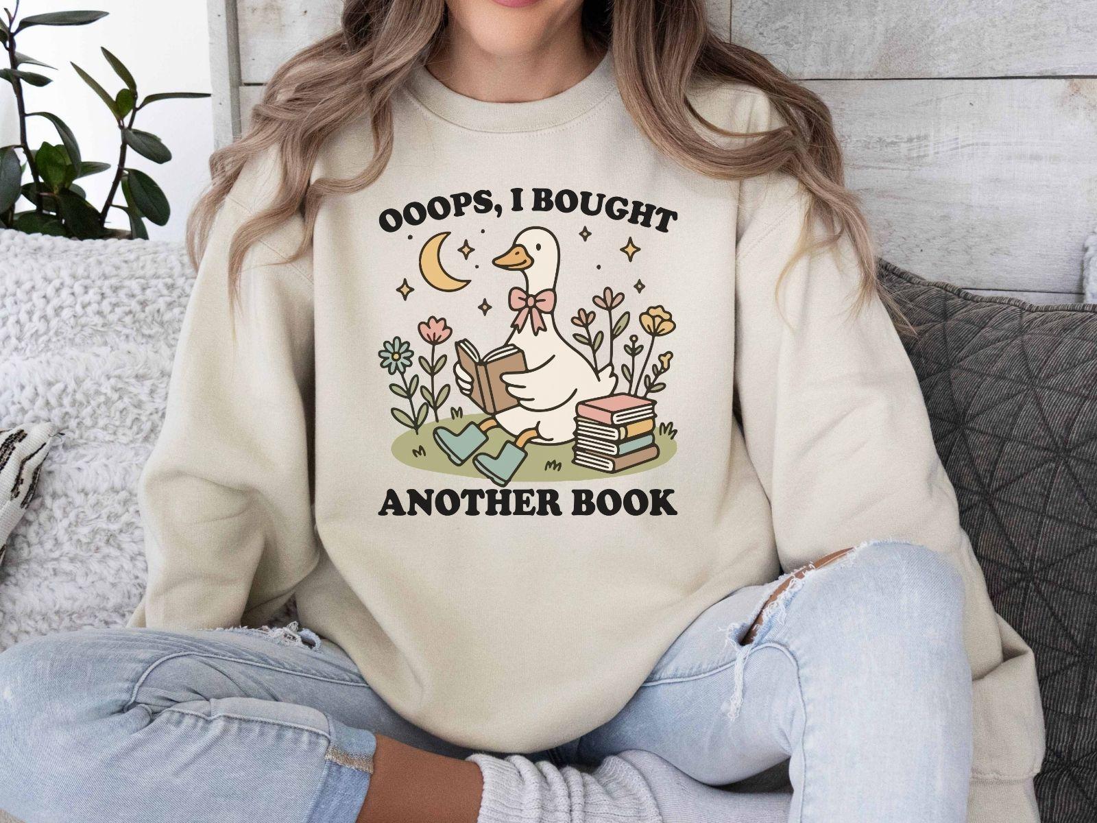 A Gildan 18000 sweatshirt with the saying "oops i bought another book"
